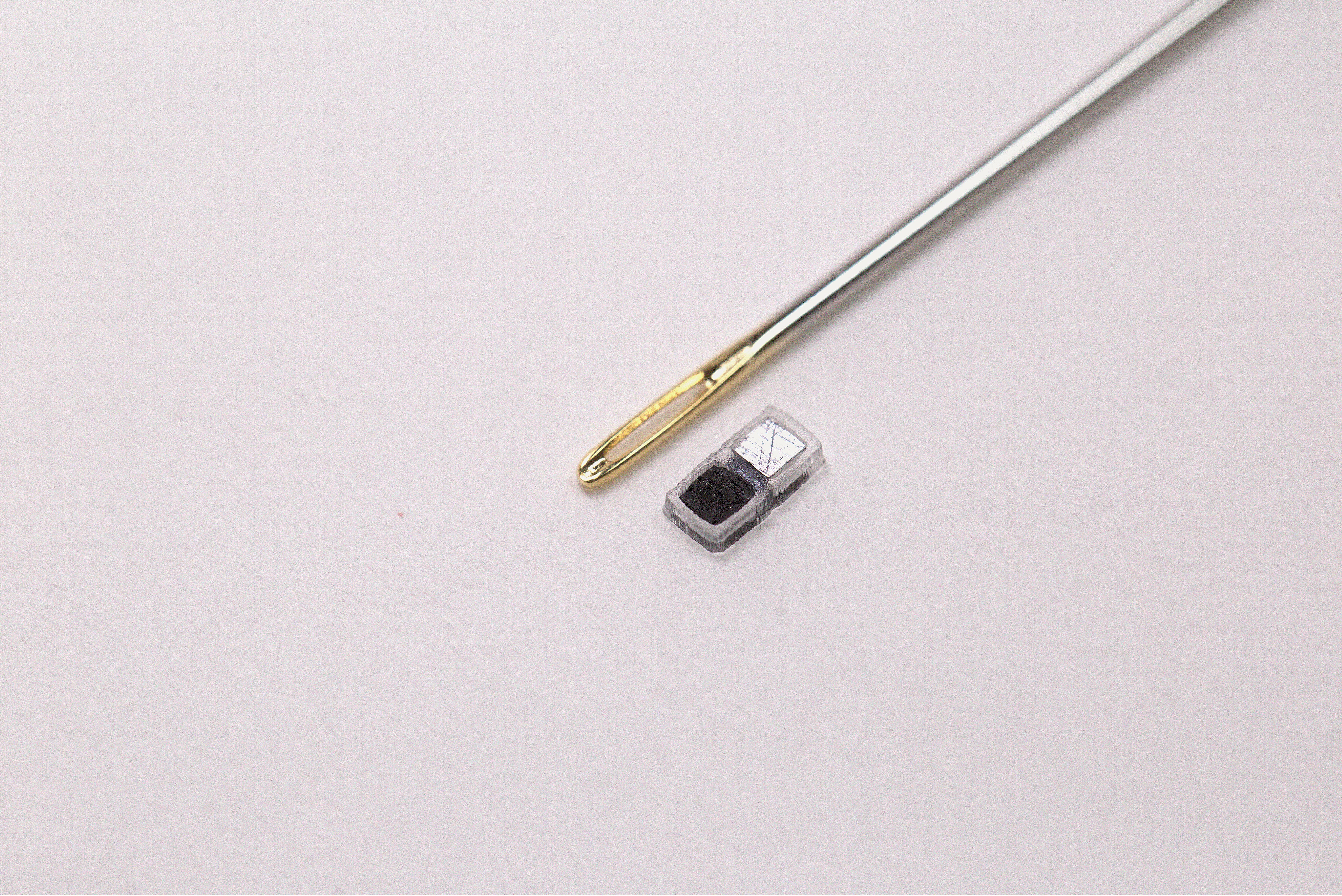 The world’s smallest pacemaker (shown here next to the eye of a sewing needle for scale)