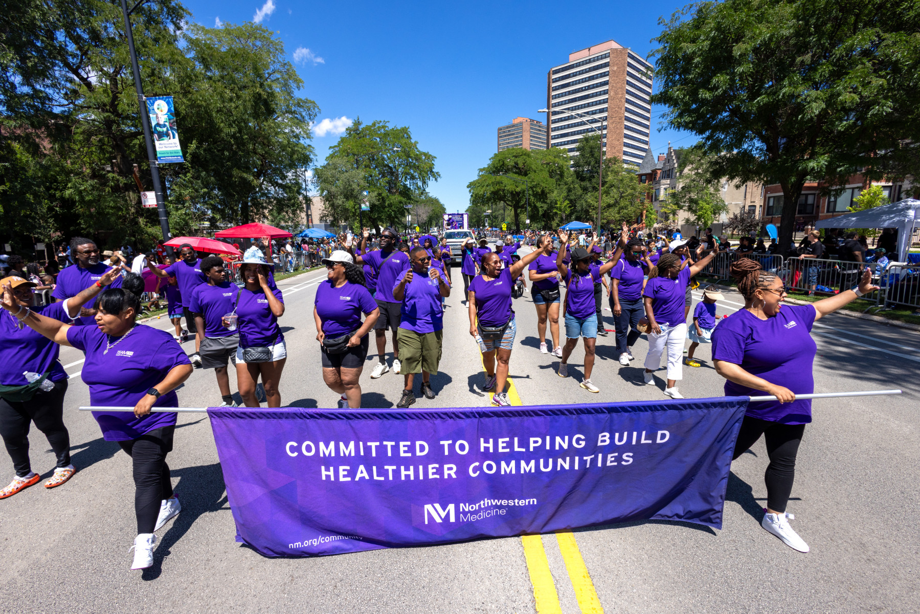 People marching in purple during the Northwestern Medicine parade
